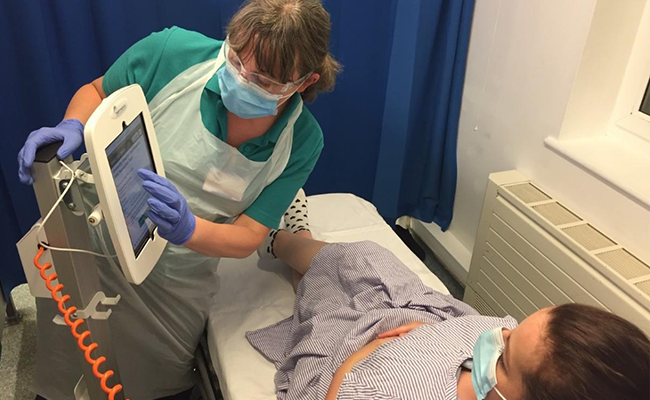 Nurse and patient using iPad Cart